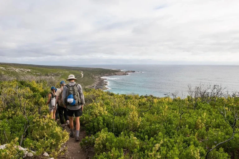 Hiker on the clifftop trail from Contos to Redgate Beach